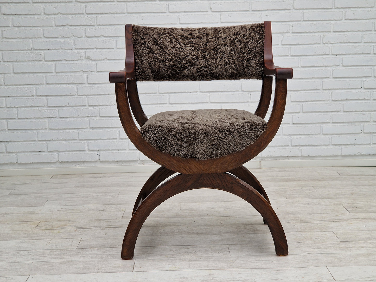 1960s, Danish design by Henning Kjærnulf, chair model "Kurul", sheepskin, dark oak.