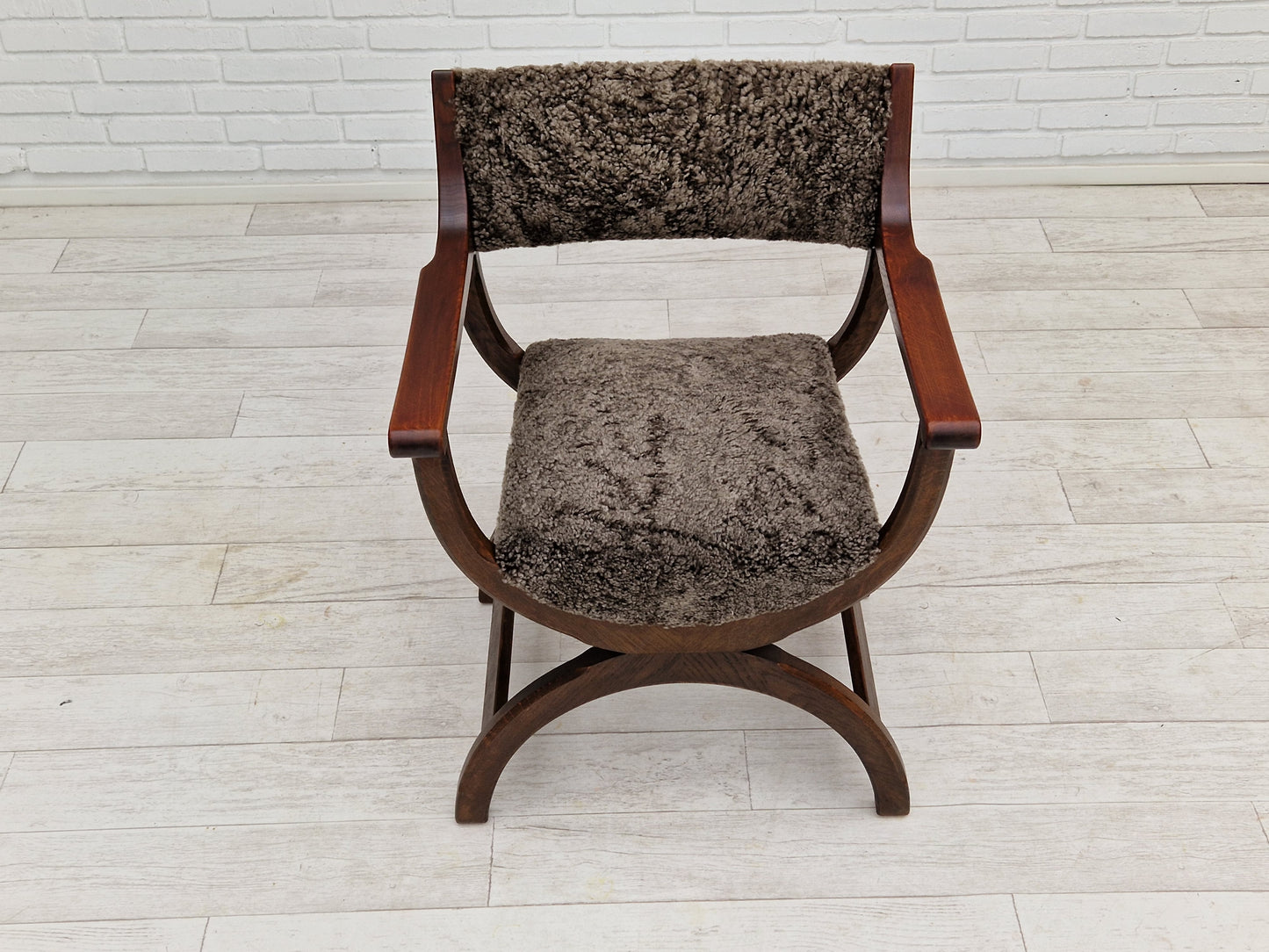 1960s, Danish design by Henning Kjærnulf, chair model "Kurul", sheepskin, dark oak.