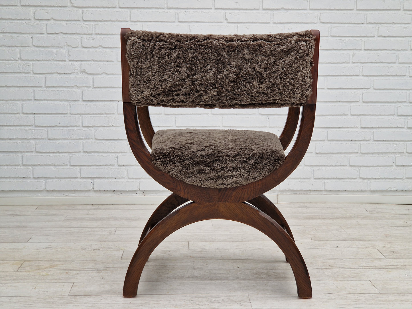 1960s, Danish design by Henning Kjærnulf, chair model "Kurul", sheepskin, dark oak.