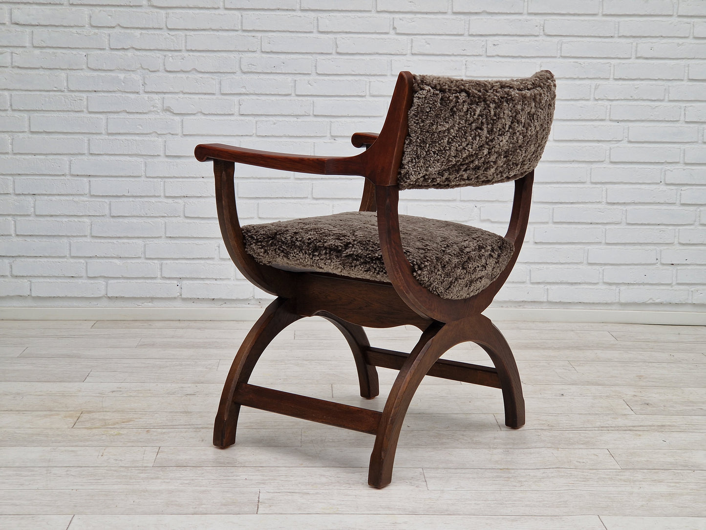 1960s, Danish design by Henning Kjærnulf, chair model "Kurul", sheepskin, dark oak.