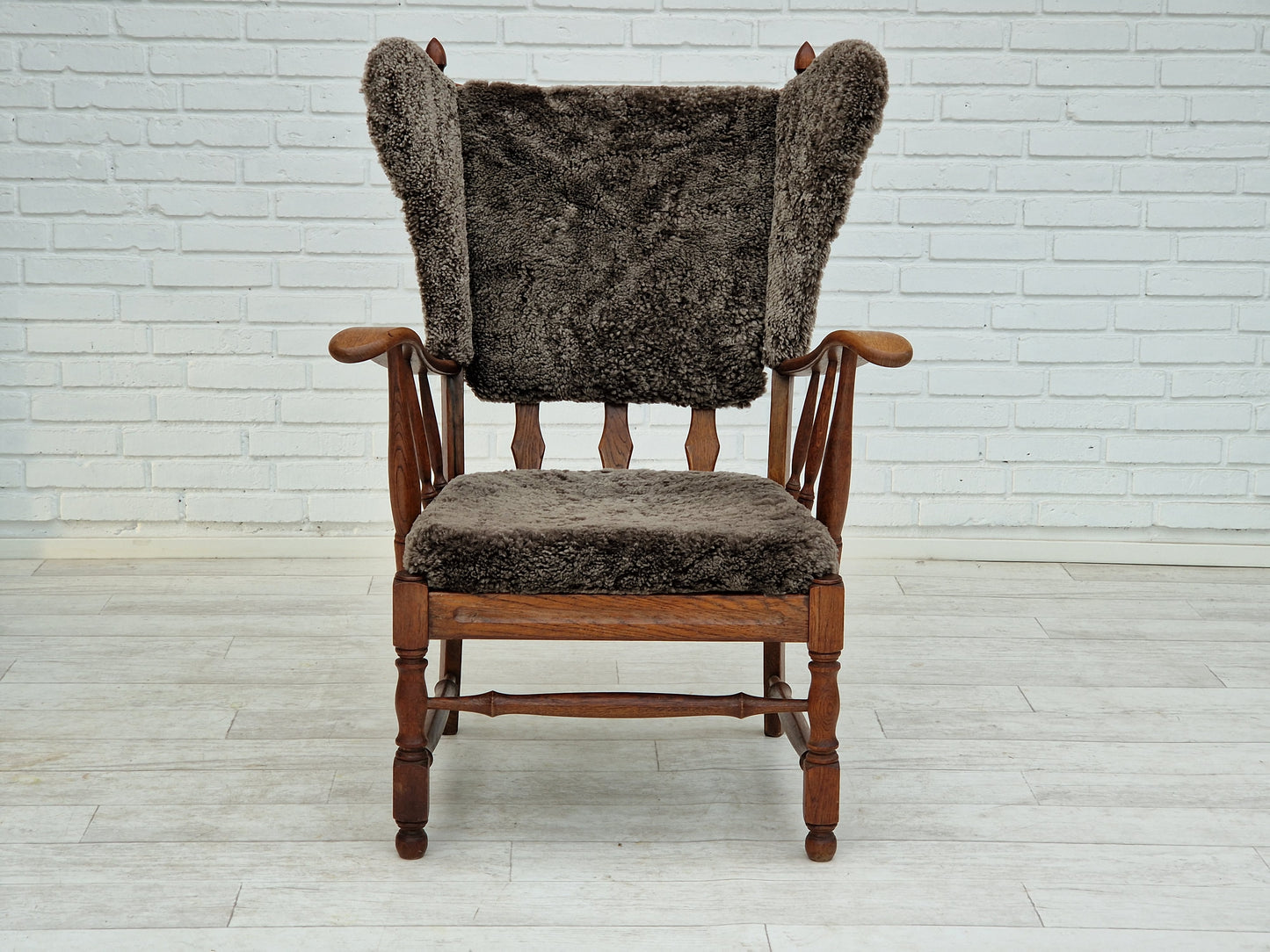 1960s, Danish design, renovated-reupholstered high-back ear flap chair, sheepskin, oak wood