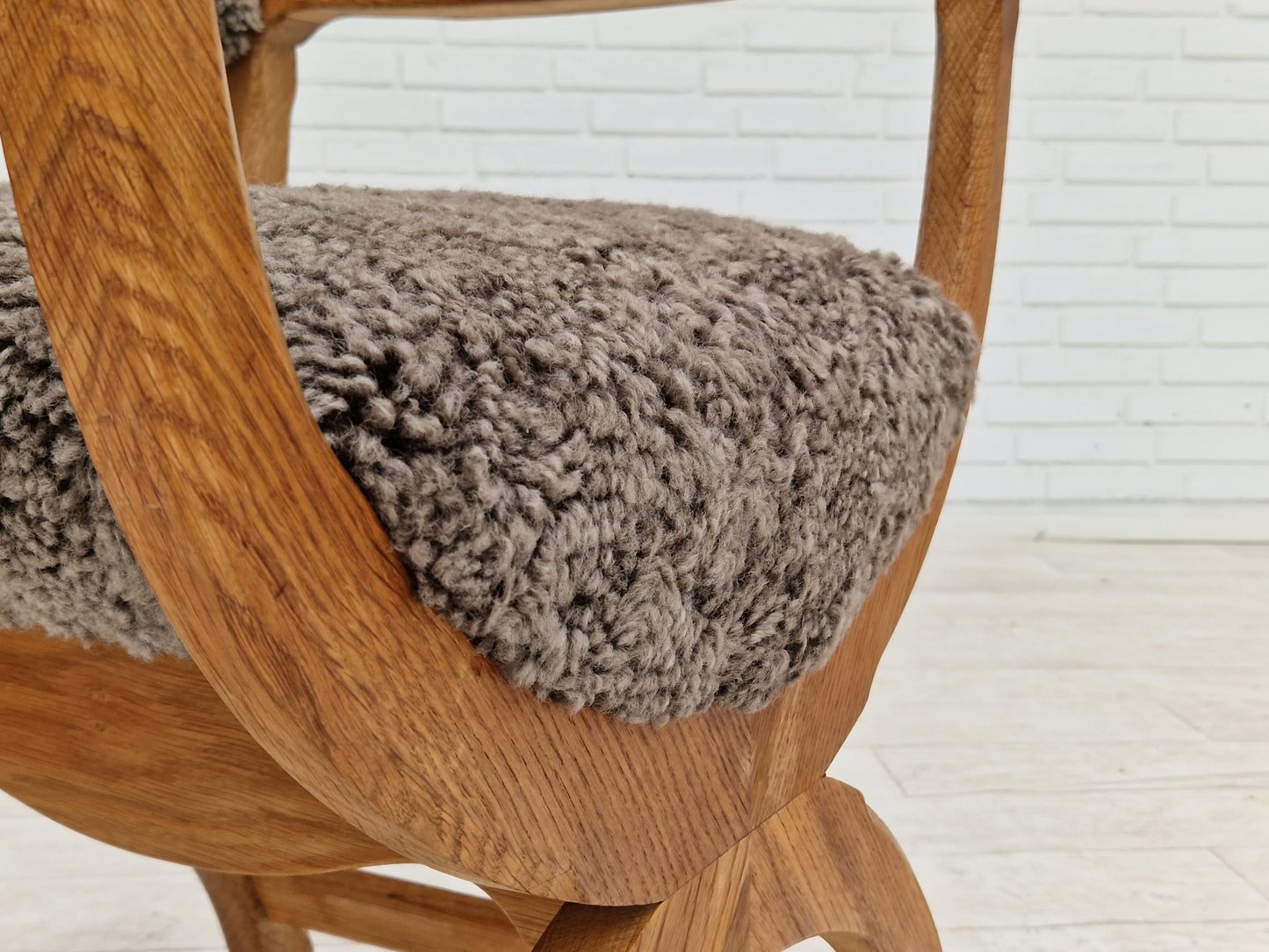 1960s, Danish design by Henning Kjærnulf, chair model "Kurul", sheepskin, oak wood.