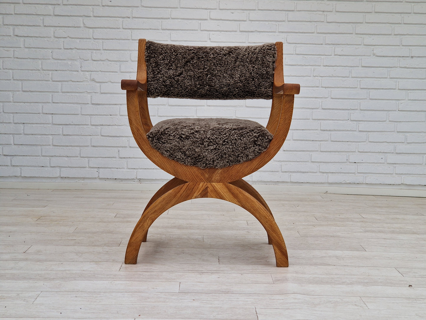 1960s, Danish design by Henning Kjærnulf, chair model "Kurul", sheepskin, oak wood.