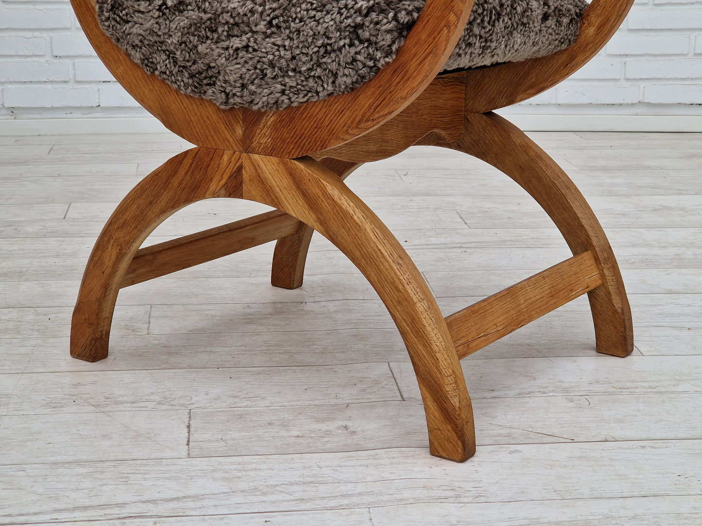 1960s, Danish design by Henning Kjærnulf, chair model "Kurul", sheepskin, oak wood.