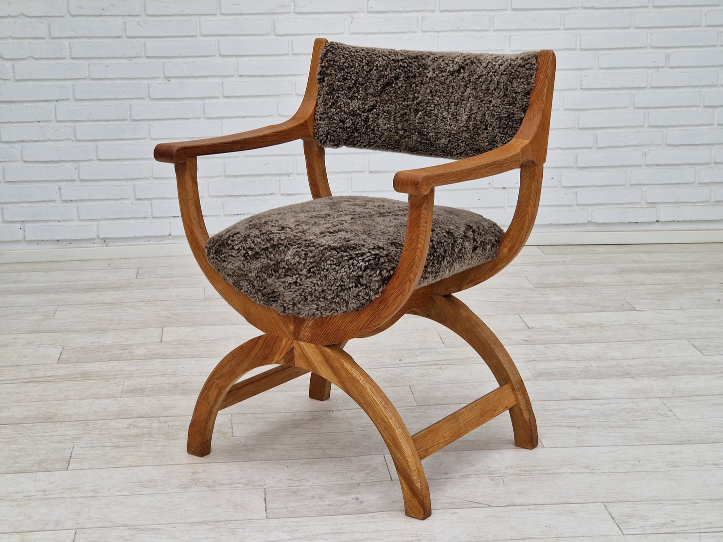 1960s, Danish design by Henning Kjærnulf, chair model "Kurul", sheepskin, oak wood.