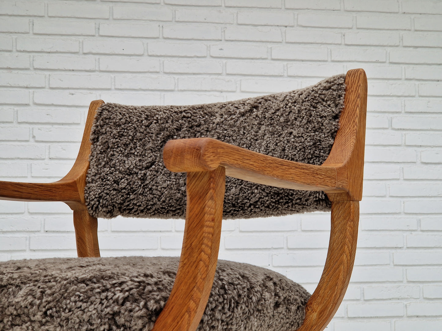 1960s, Danish design by Henning Kjærnulf, chair model "Kurul", sheepskin, oak wood.