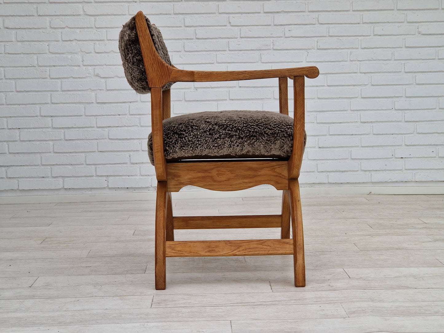 1960s, Danish design by Henning Kjærnulf, chair model "Kurul", sheepskin, oak wood.