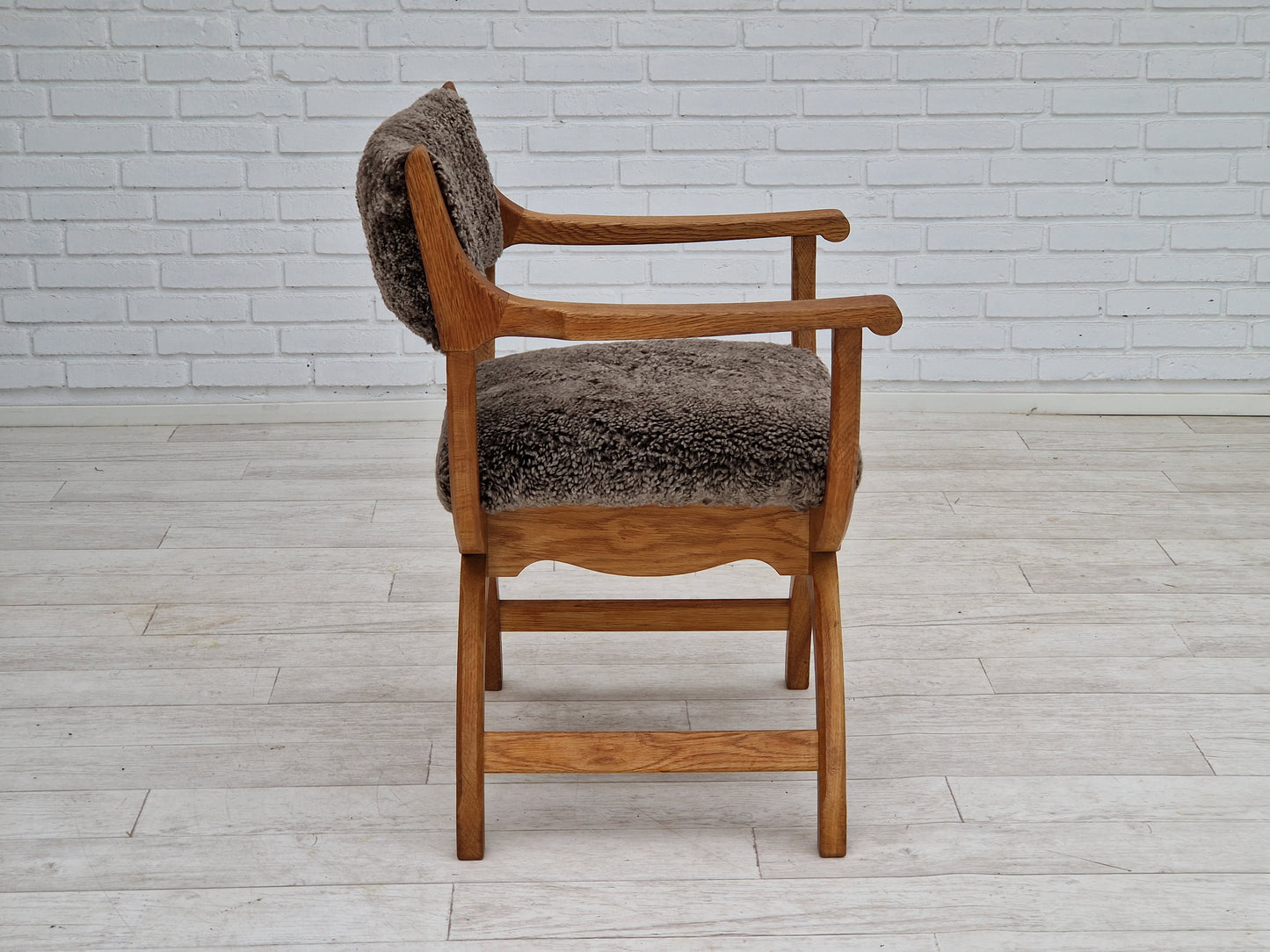 1960s, Danish design by Henning Kjærnulf, chair model "Kurul", sheepskin, oak wood.