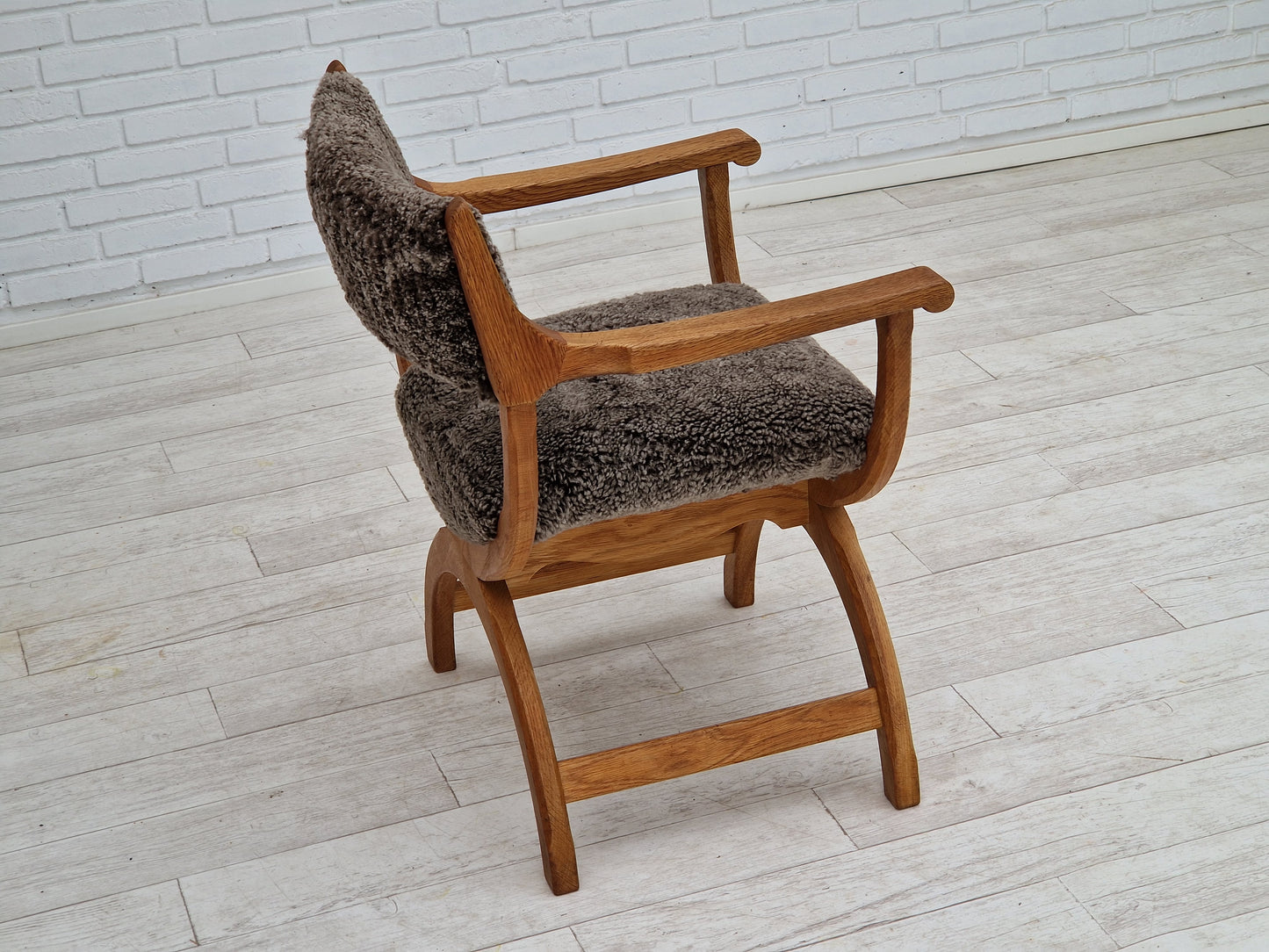 1960s, Danish design by Henning Kjærnulf, chair model "Kurul", sheepskin, oak wood.