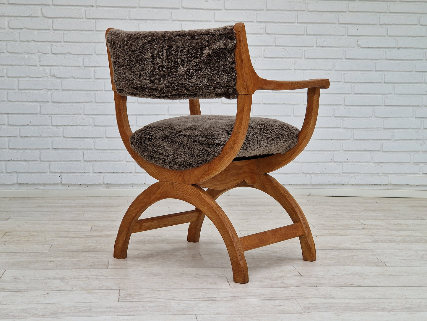 1960s, Danish design by Henning Kjærnulf, chair model "Kurul", sheepskin, oak wood.