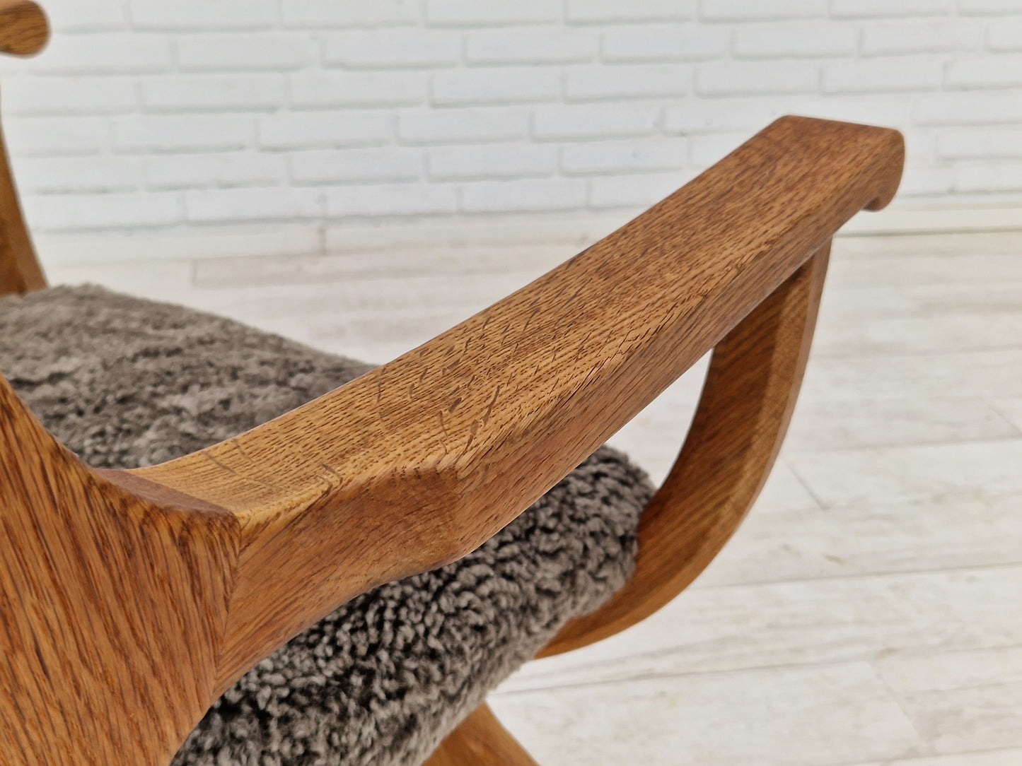 1960s, Danish design by Henning Kjærnulf, chair model "Kurul", sheepskin, oak wood.