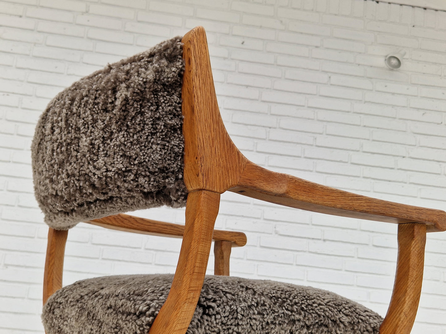 1960s, Danish design by Henning Kjærnulf, chair model "Kurul", sheepskin, oak wood.