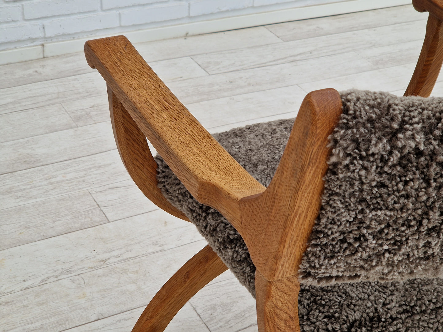 1960s, Danish design by Henning Kjærnulf, chair model "Kurul", sheepskin, oak wood.