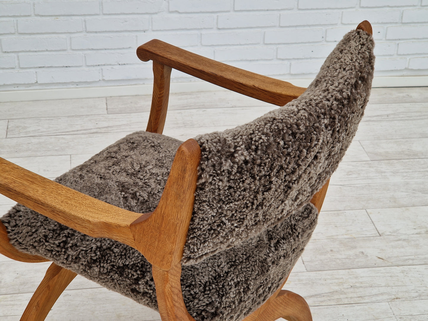 1960s, Danish design by Henning Kjærnulf, chair model "Kurul", sheepskin, oak wood.