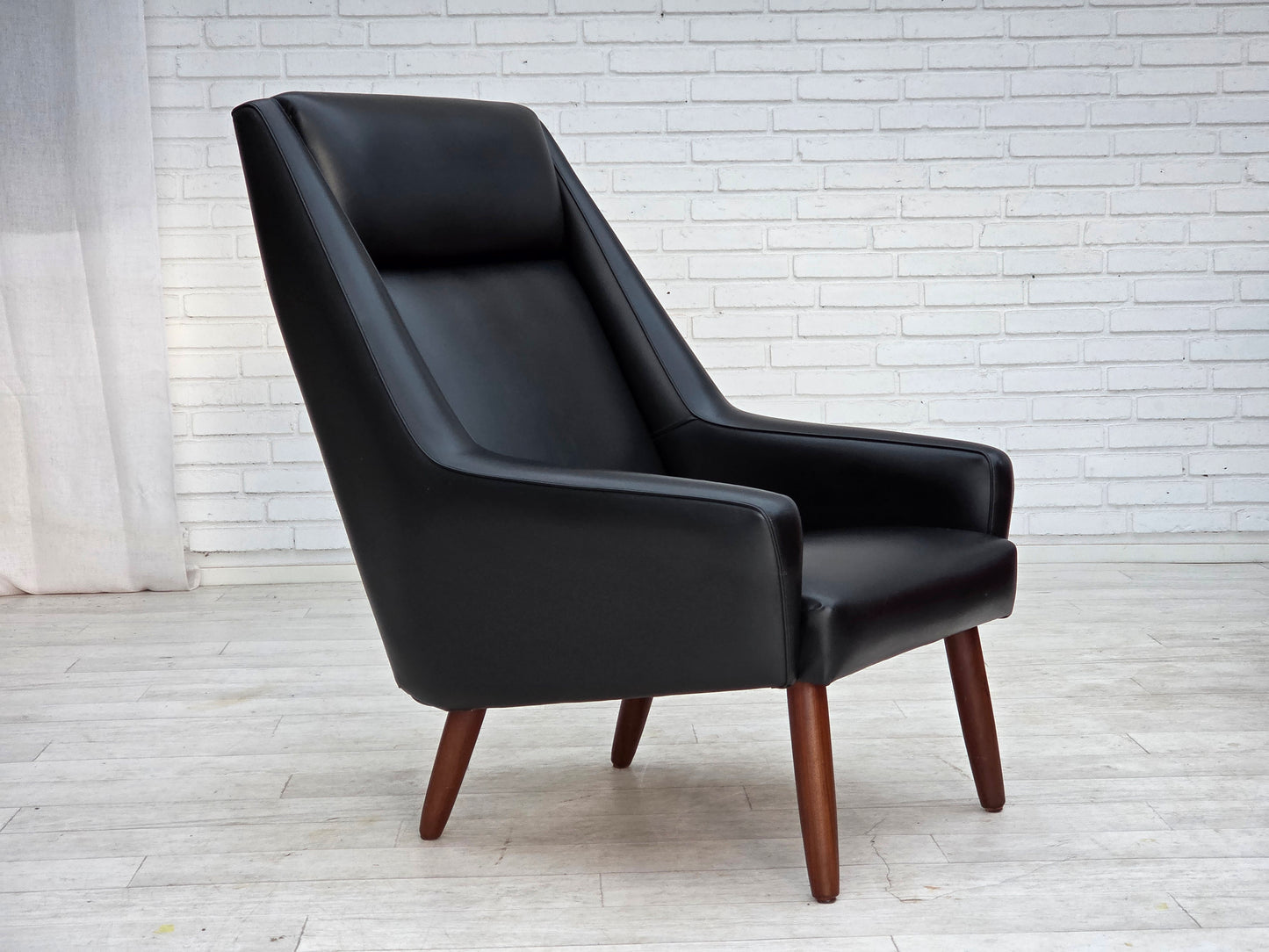 1970s, Danish highback armchair, black artificial leather, teak wood legs.