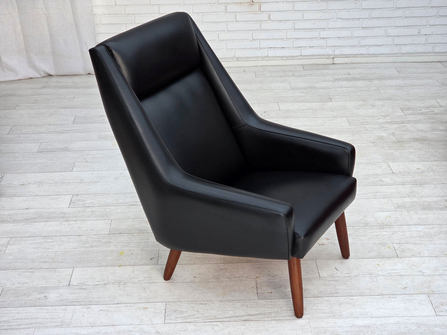 1970s, Danish highback armchair, black artificial leather, teak wood legs.