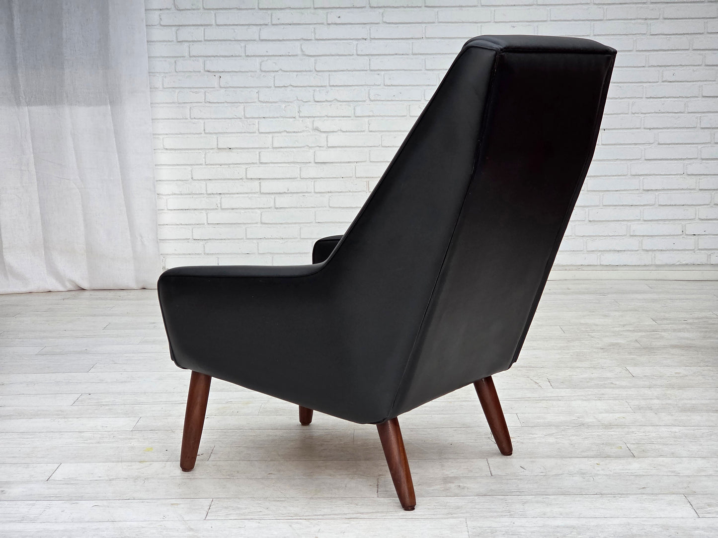 1970s, Danish highback armchair, black artificial leather, teak wood legs.