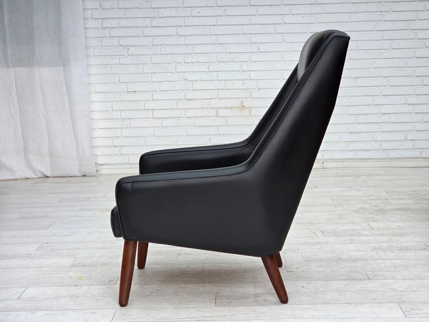 1970s, Danish highback armchair, black artificial leather, teak wood legs.