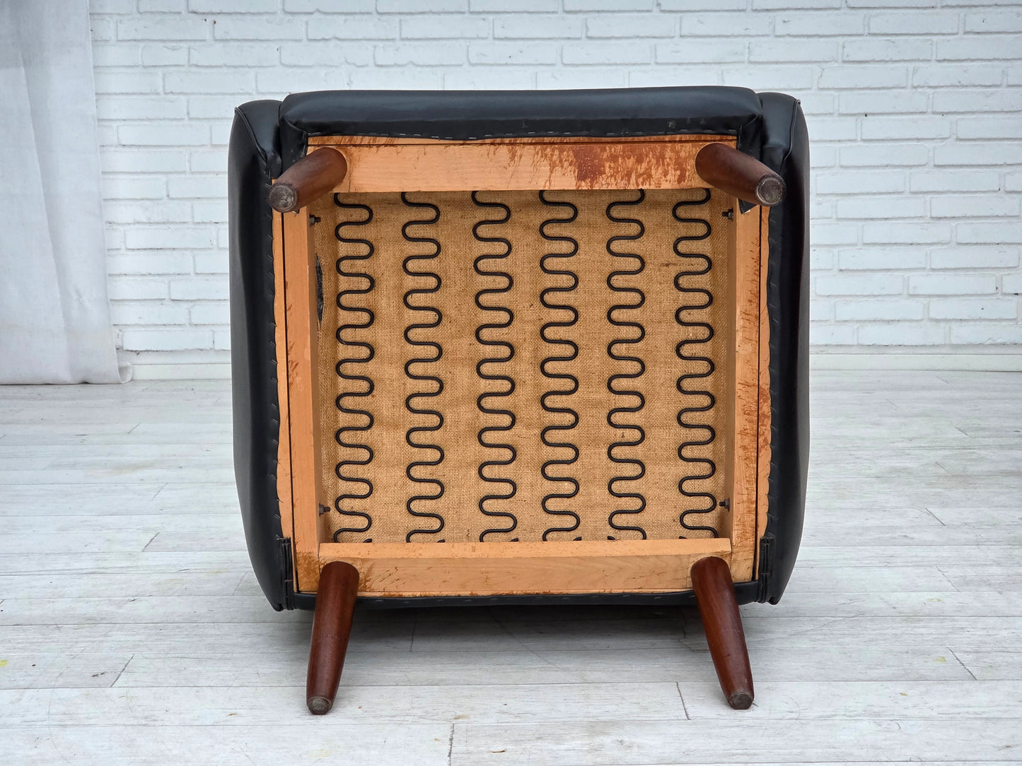 1970s, Danish highback armchair, black artificial leather, teak wood legs.
