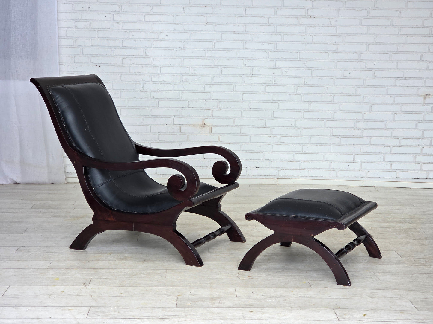 1970s, vintage armchair with footstool, black furniture leather.