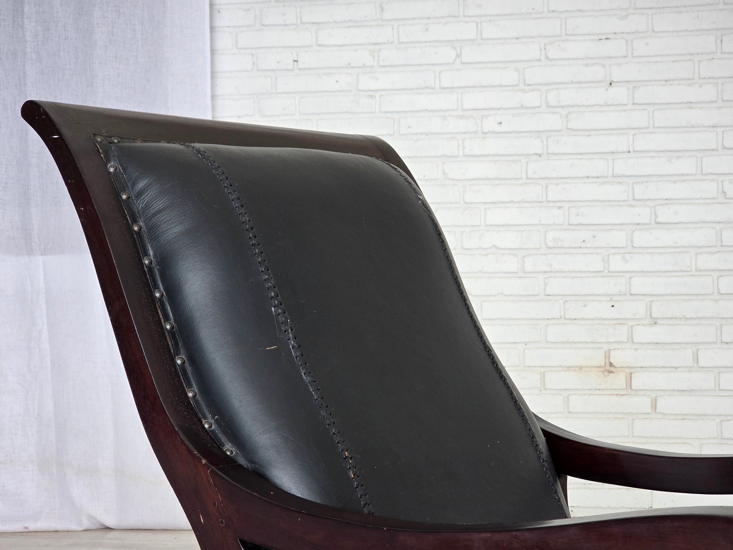 1970s, vintage armchair with footstool, black furniture leather.