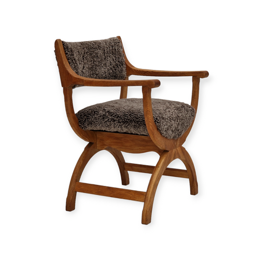 1960s, Danish design by Henning Kjærnulf, chair model "Kurul", sheepskin, oak wood.